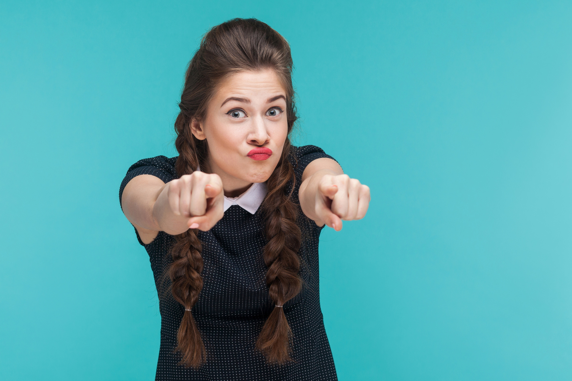 Closeup portrait of crazy woman pointing finger at camera.